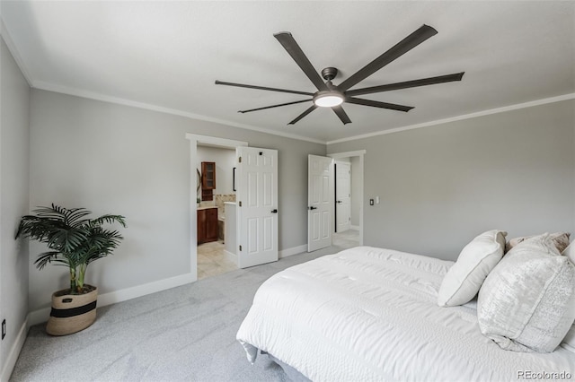 carpeted bedroom featuring ceiling fan, ornamental molding, and ensuite bath