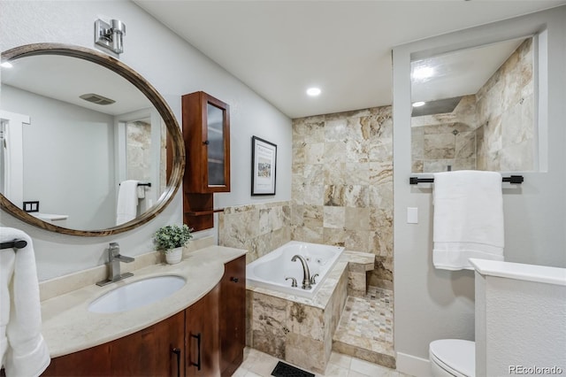 bathroom with tiled bath, tile patterned flooring, vanity, and toilet