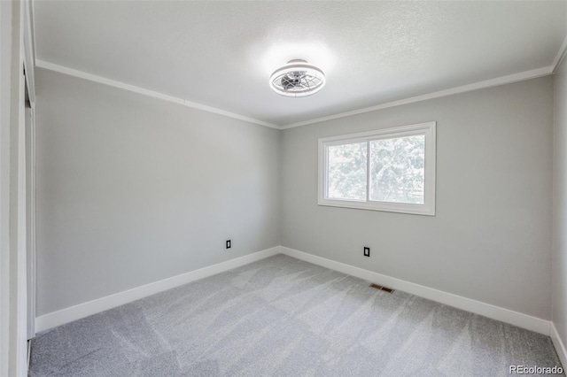 spare room with carpet flooring and ornamental molding