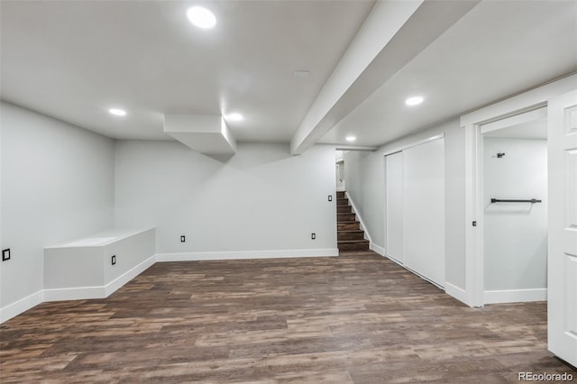 basement with dark hardwood / wood-style floors