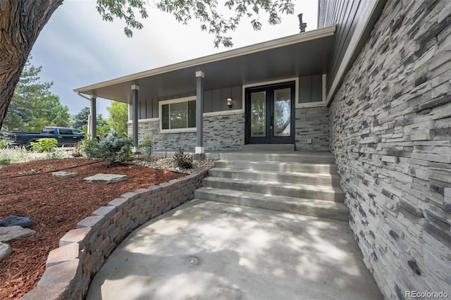 entrance to property featuring french doors and a porch