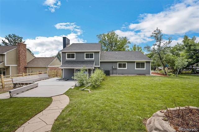 back of house with central AC, a yard, and a patio