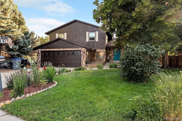 view of front of property with a front yard and a garage