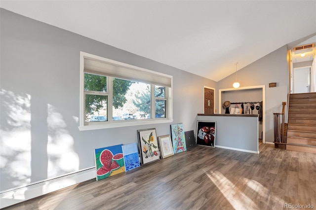 interior space with lofted ceiling, a baseboard radiator, and hardwood / wood-style floors