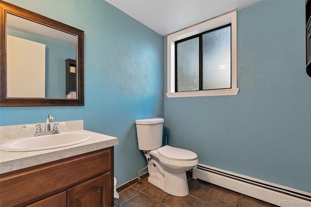 bathroom featuring toilet, baseboard heating, tile patterned floors, and vanity