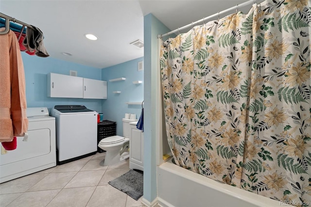 bathroom with toilet, washer and dryer, shower / bath combo with shower curtain, and tile patterned floors