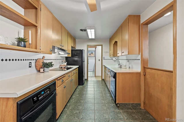 kitchen with sink, decorative backsplash, and black appliances