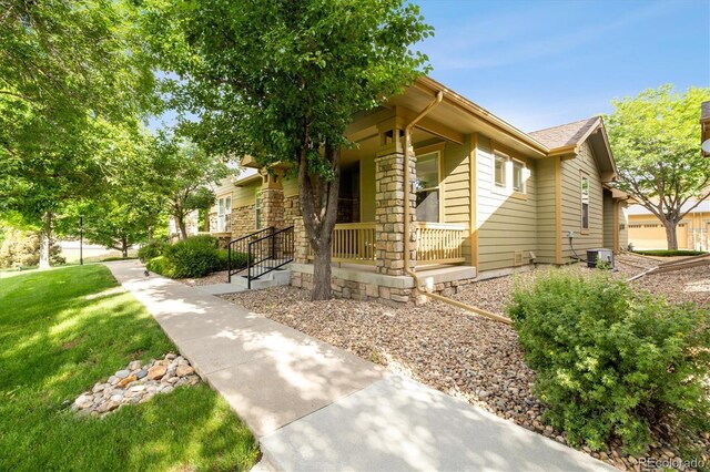 view of front of house featuring a front lawn and covered porch