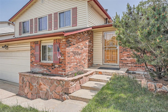 1824 S Granby St, Aurora, CO 80012 - view of front of house with brick siding, a garage, and concrete driveway