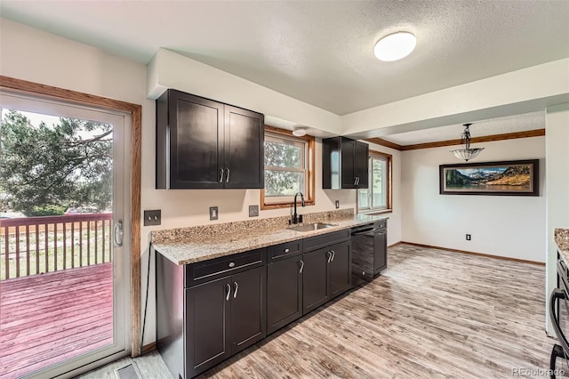 1824 S Granby St, Aurora, CO 80012 - kitchen featuring a sink, dishwasher, baseboards, light wood-style floors, and a textured ceiling