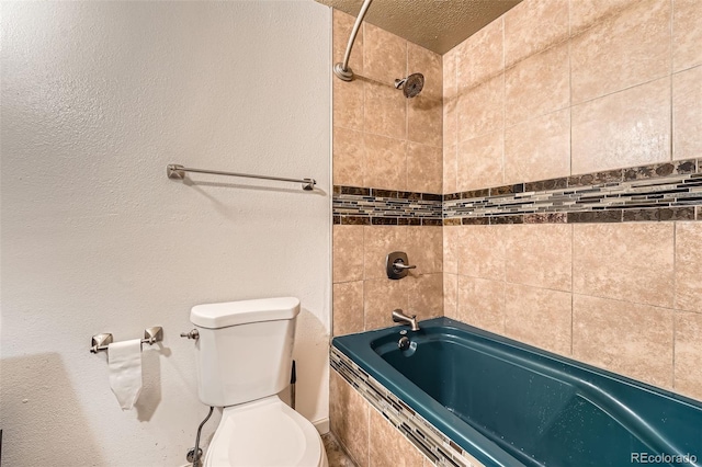 1824 S Granby St, Aurora, CO 80012 - bathroom featuring toilet, tiled shower / bath combo, and a textured ceiling