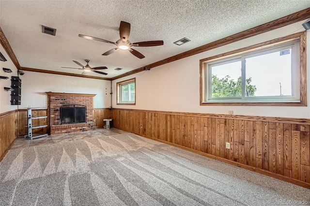 1824 S Granby St, Aurora, CO 80012 - unfurnished living room with crown molding, a textured ceiling, wooden walls, ceiling fan, and a wainscoted wall