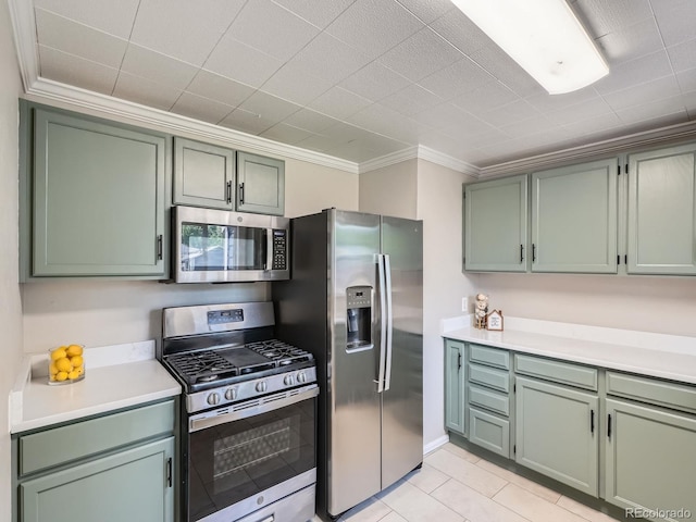 3750 S Galapago St, Englewood, CO 80110 - kitchen featuring appliances with stainless steel finishes, ornamental molding, green cabinetry, light countertops, and light tile patterned floors