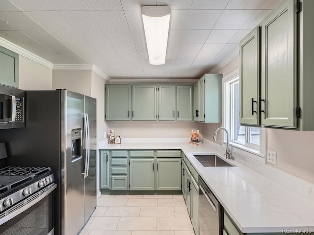 3750 S Galapago St, Englewood, CO 80110 - kitchen featuring green cabinetry, stainless steel appliances, crown molding, and light tile patterned floors