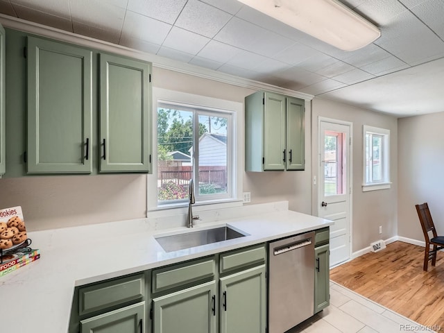 3750 S Galapago St, Englewood, CO 80110 - kitchen featuring green cabinetry, stainless steel dishwasher, light countertops, and healthy amount of natural light