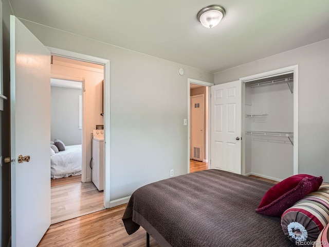 3750 S Galapago St, Englewood, CO 80110 - bedroom featuring washer / dryer, light wood-style floors, and a closet