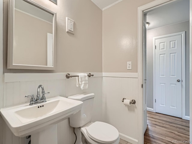 3750 S Galapago St, Englewood, CO 80110 - bathroom with wood finished floors, a wainscoted wall, and crown molding