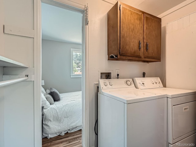 3750 S Galapago St, Englewood, CO 80110 - laundry room featuring cabinet space, washer and clothes dryer, and wood finished floors