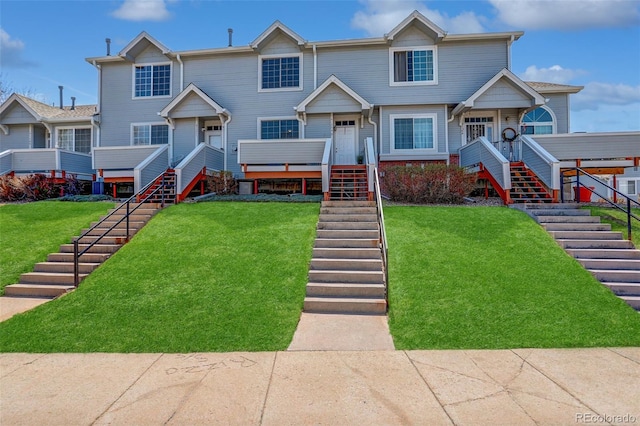 4120 E 119th Pl Unit B, Thornton, CO 80233 - townhome / multi-family property with stairs, a front lawn, and a wooden deck