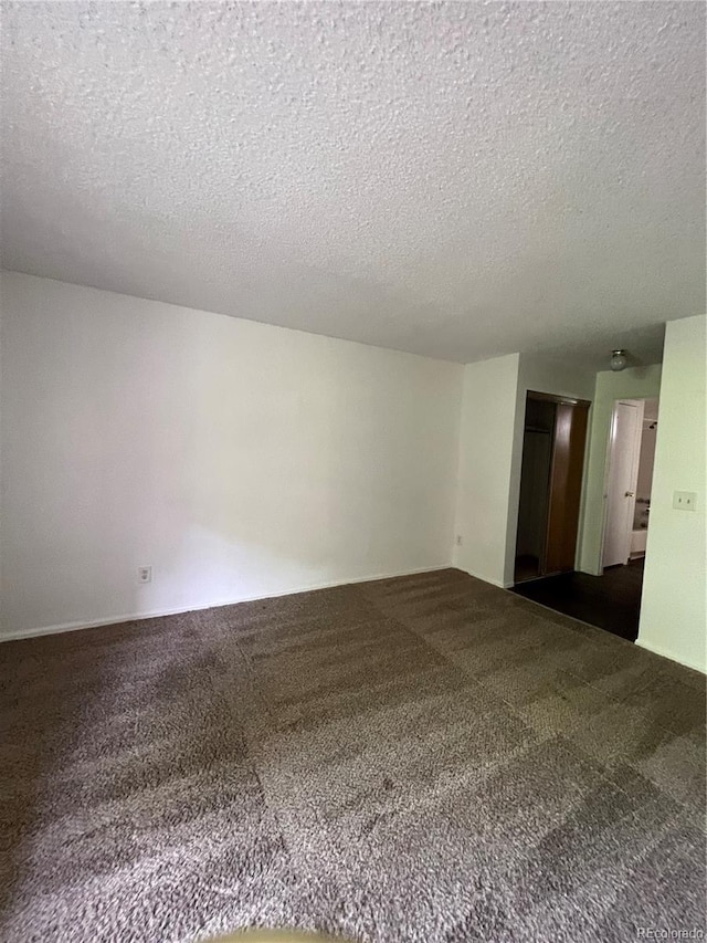 14852 E Kentucky Dr Unit 934, Aurora, CO 80012 - unfurnished room featuring a textured ceiling and dark carpet