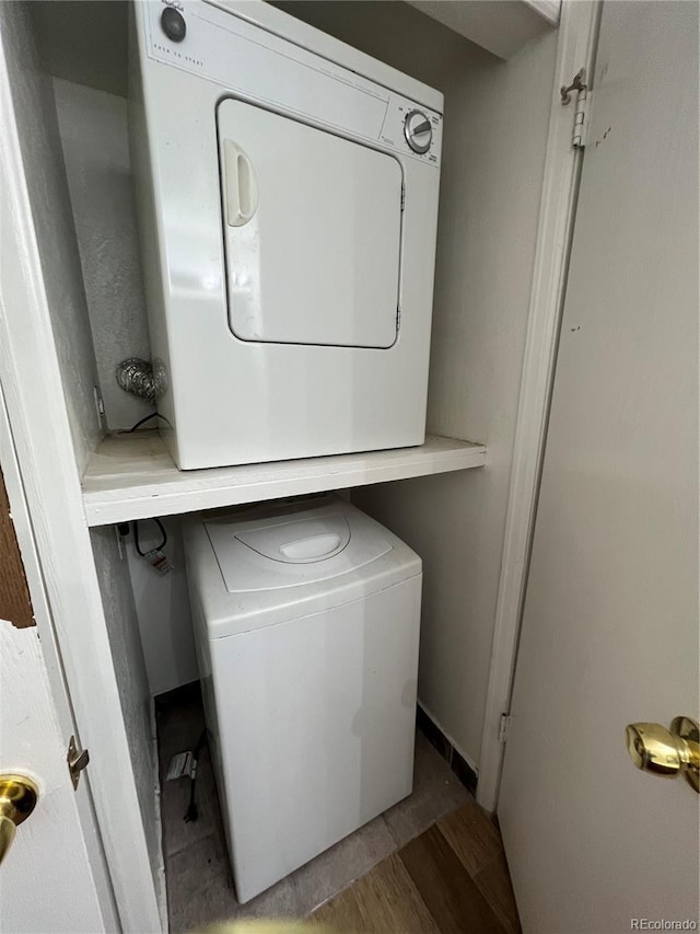 14852 E Kentucky Dr Unit 934, Aurora, CO 80012 - laundry area with stacked washer / dryer and light wood-style floors
