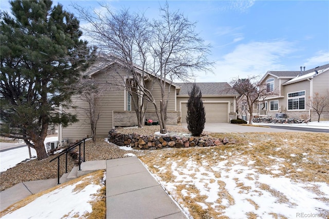 view of front facade with a garage, concrete driveway, and brick siding