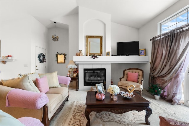 carpeted living room featuring high vaulted ceiling and a tiled fireplace