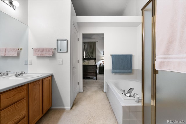 full bath featuring connected bathroom, carpet floors, vanity, baseboards, and a bath