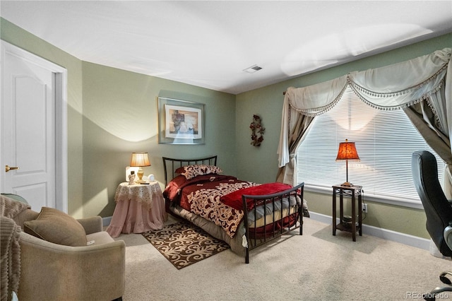 bedroom featuring baseboards, visible vents, and carpet flooring