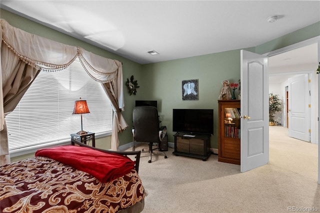 bedroom with light carpet, baseboards, and visible vents