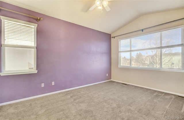 carpeted spare room featuring ceiling fan and lofted ceiling