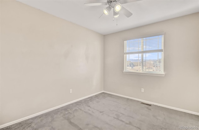 spare room with carpet flooring and ceiling fan