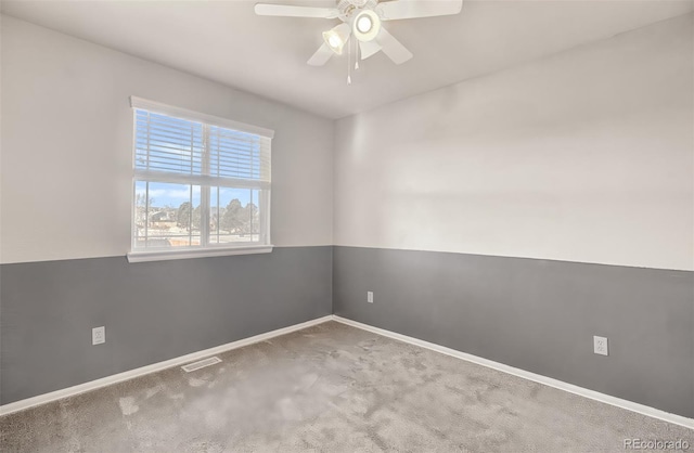 empty room with ceiling fan and carpet