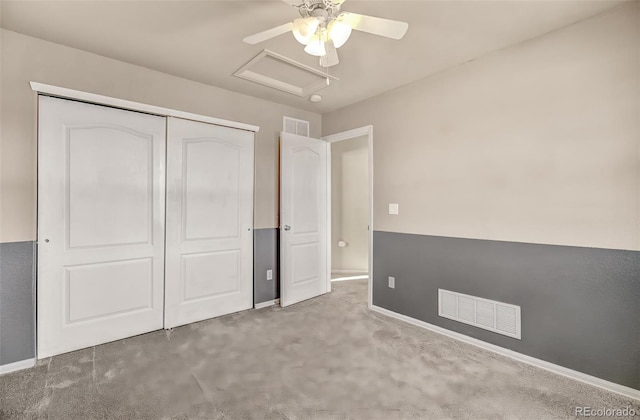 unfurnished bedroom featuring ceiling fan, a closet, and carpet