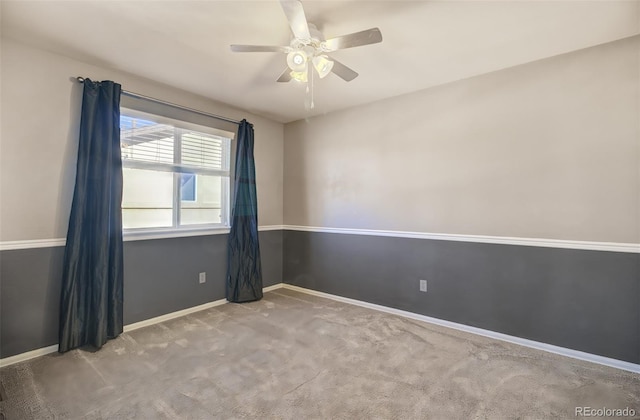 unfurnished room featuring ceiling fan and light carpet