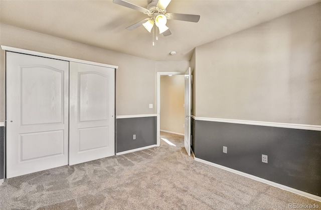 unfurnished bedroom with ceiling fan, light colored carpet, and a closet