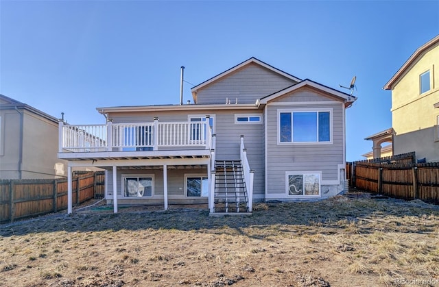 back of house with a wooden deck