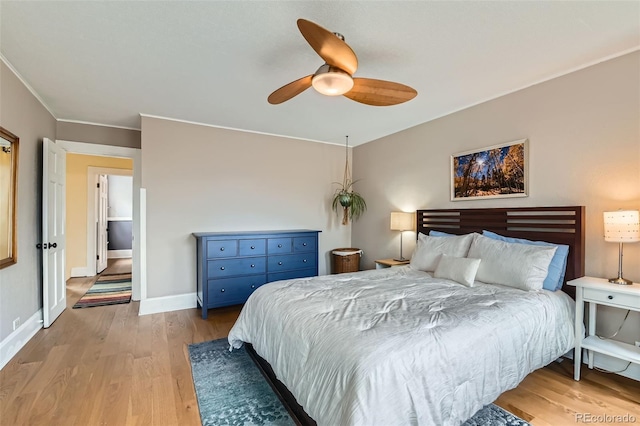 bedroom featuring light wood-style flooring, baseboards, ceiling fan, and crown molding