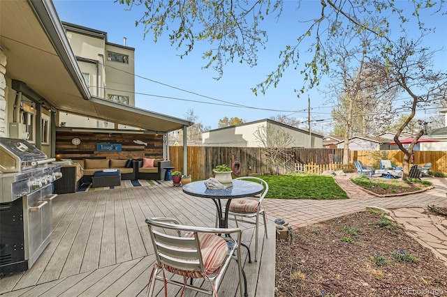 wooden deck with a fenced backyard, a patio area, and an outdoor hangout area