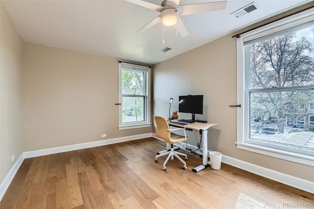 office with baseboards, wood finished floors, visible vents, and a ceiling fan