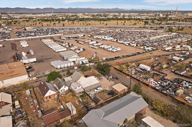 5182 Thompson Ct, Denver, CO 80216 - aerial overview of property's location featuring an industrial area and mountains