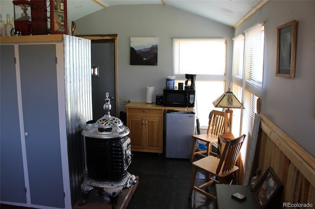 kitchen with lofted ceiling and fridge