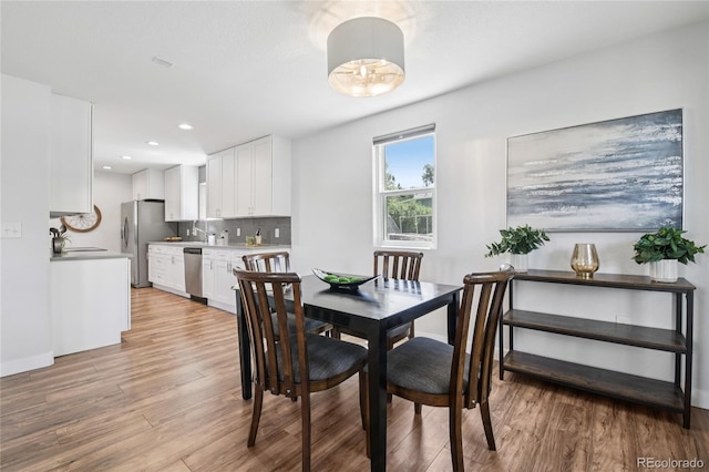 112 S Hooker St, Denver, CO 80219 - dining area with light wood finished floors and recessed lighting