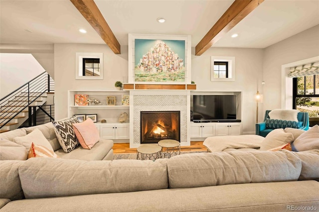 700 Cheyenne St, Golden, CO 80401 - living room featuring beamed ceiling, a wealth of natural light, stairway, and wood finished floors