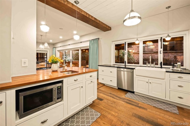 700 Cheyenne St, Golden, CO 80401 - kitchen featuring a sink, stainless steel appliances, butcher block counters, and wood finished floors