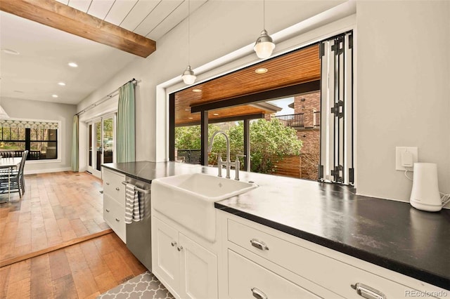 700 Cheyenne St, Golden, CO 80401 - kitchen featuring a sink, light wood-style floors, decorative light fixtures, stainless steel dishwasher, and beamed ceiling