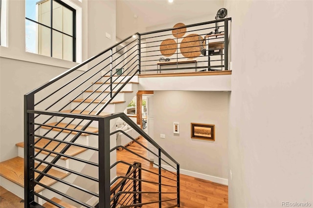 700 Cheyenne St, Golden, CO 80401 - stairway featuring baseboards, wood finished floors, and a high ceiling