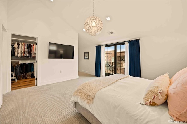 700 Cheyenne St, Golden, CO 80401 - carpeted bedroom featuring a walk in closet, baseboards, lofted ceiling, visible vents, and a closet