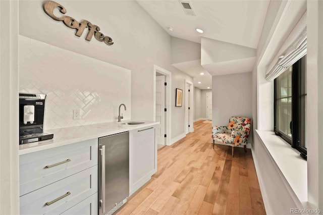 700 Cheyenne St, Golden, CO 80401 - bar with decorative backsplash, a sink, stainless steel fridge, light wood-style floors, and recessed lighting