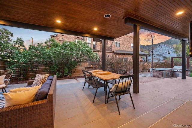 700 Cheyenne St, Golden, CO 80401 - view of patio with area for grilling, an outdoor living space, a fenced backyard, an outdoor kitchen, and outdoor dining space